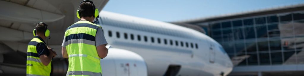 2 workers at a commercial airport airfield